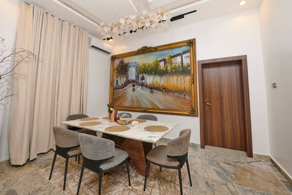Executive Lodge dining area with marble table and statement artwork
