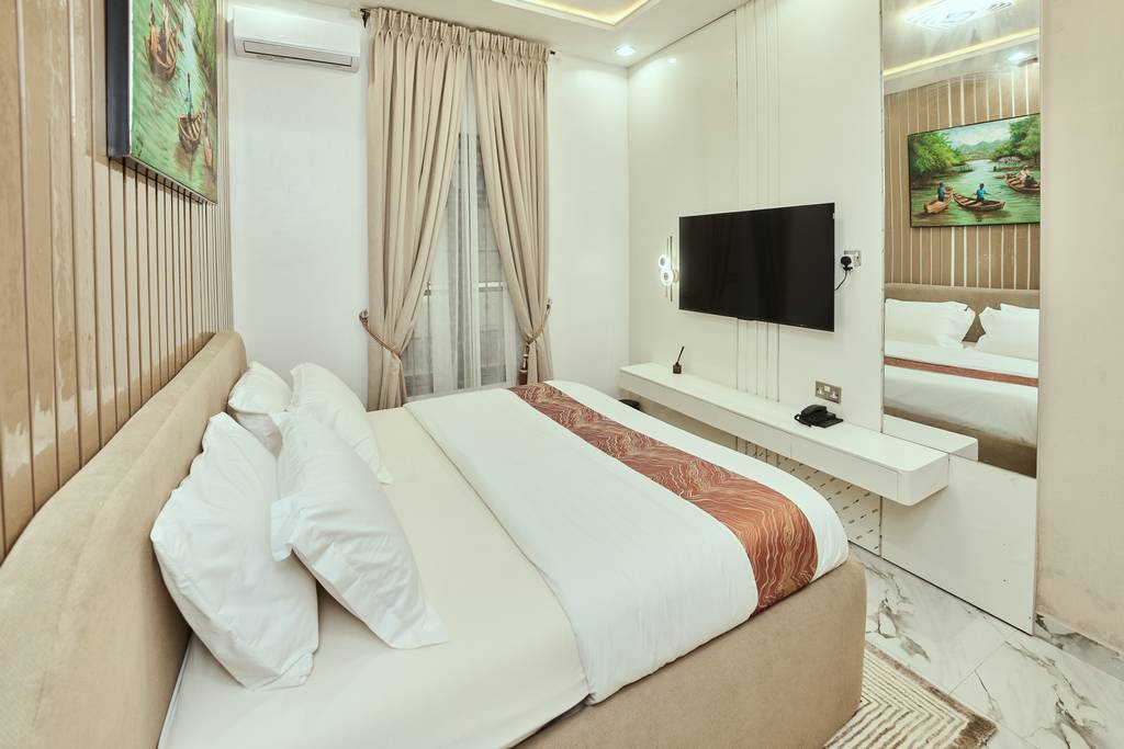 Signature Lodge bedroom with wall-mounted smart TV