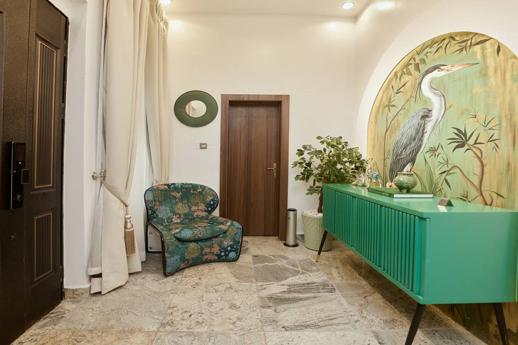 Signature Lodge entrance with heron mural and green sideboard