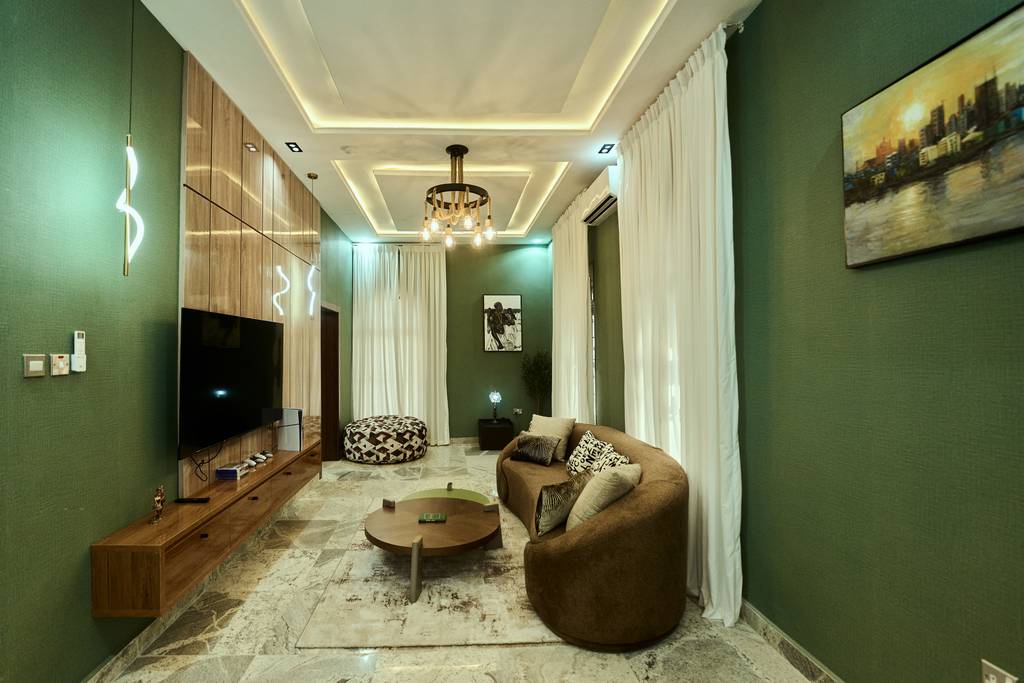 Signature Lodge lounge with green feature walls and curved sofa
